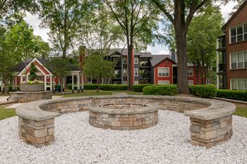 a fire pit and seating area in front of an apartment building at Elme Druid Hills, Atlanta Georgia